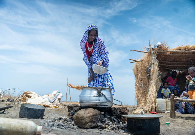 Halima begins preparations to cook a meal for Zainab and her family in their home in Al-Azaza.
